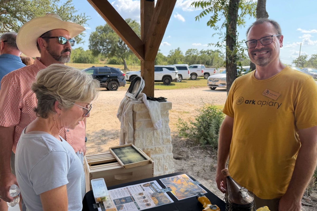 Ark of Highland Lakes volunteers raising the roofs and harvesting honey