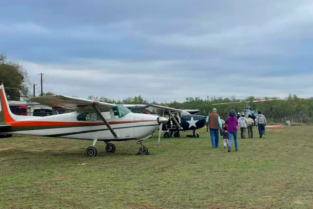 airplanes and people in a field