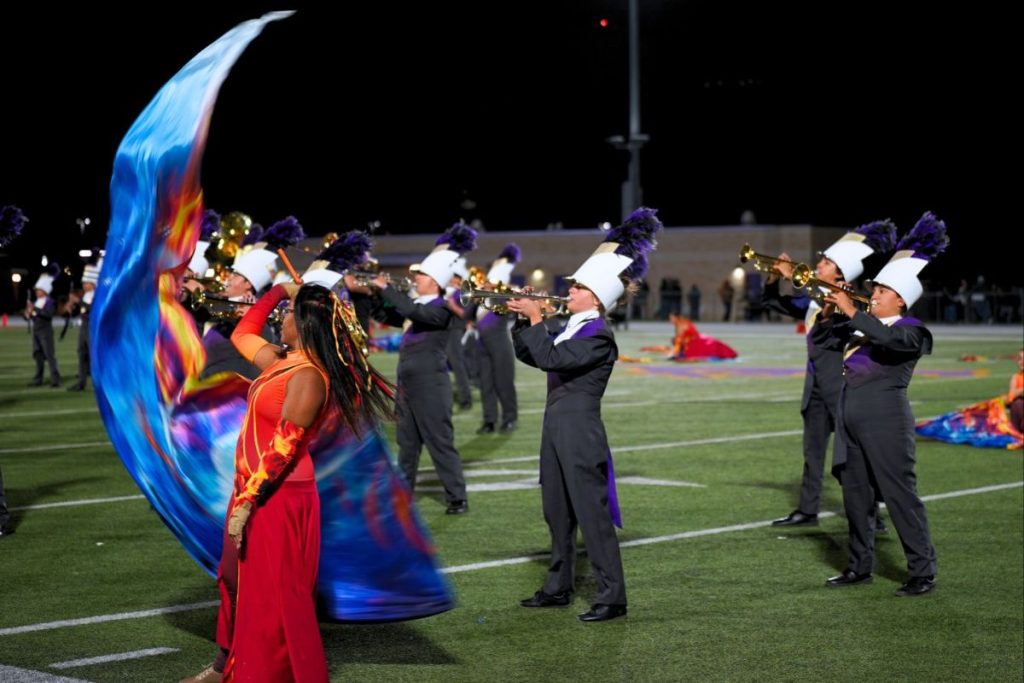 The Marble Falls Mustang Band performs its marching program, “Ignite,” during halftime of the Mustang football game a day prior to the region marching contest. Staff photo by Caden Senn